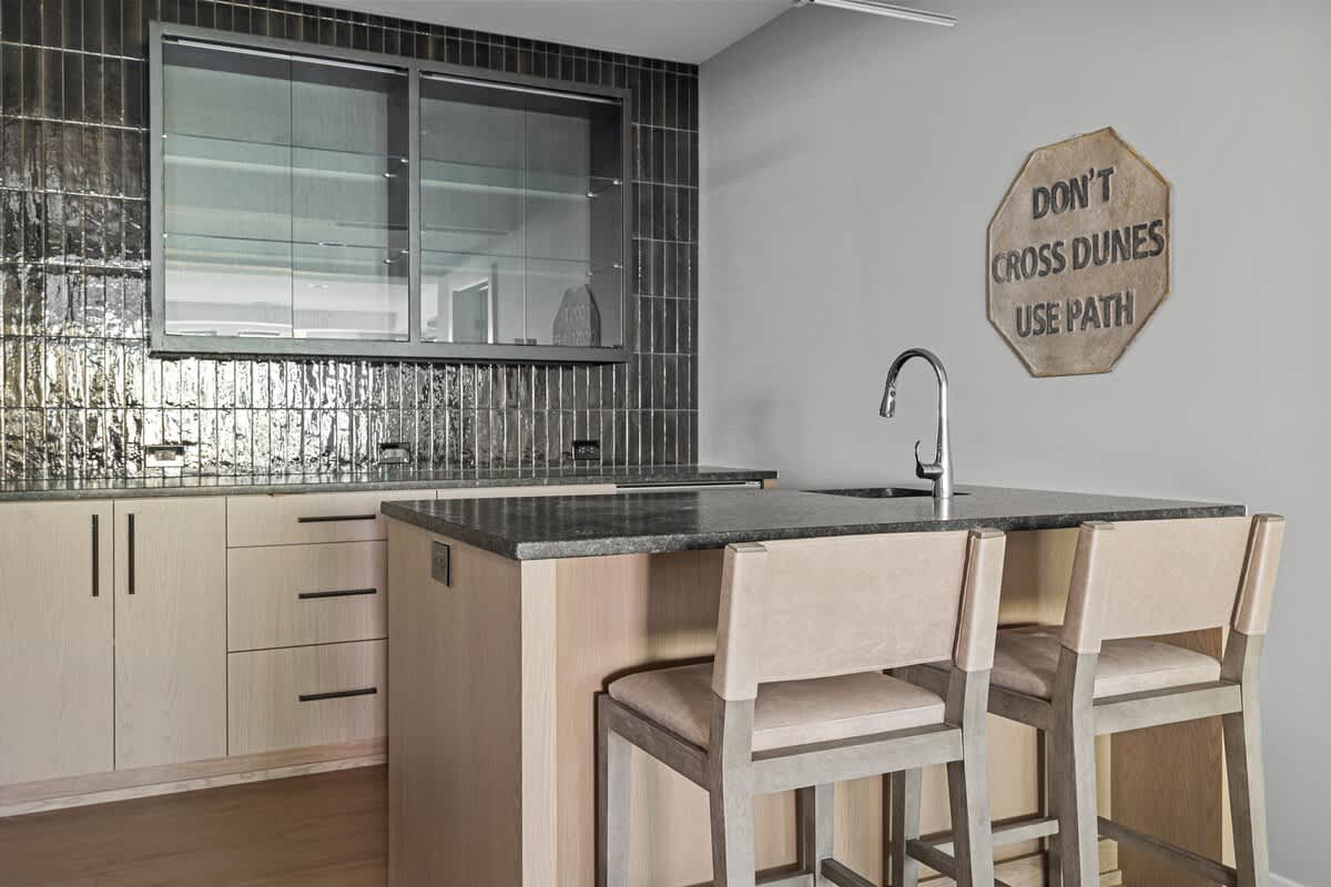 Pull up a seat and let's chat over a drink in my kitchen with a bar and two stools!