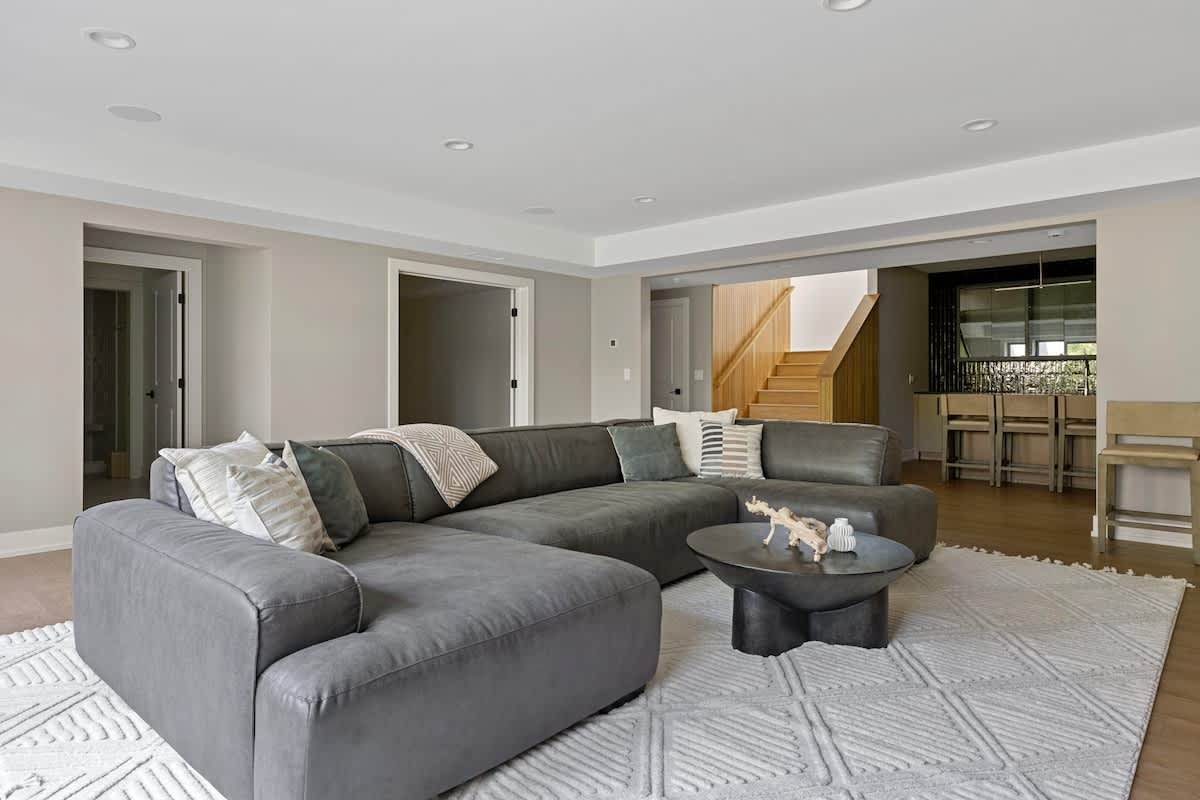 Loving the minimalist look of my living room featuring a gray couch and a white rug.