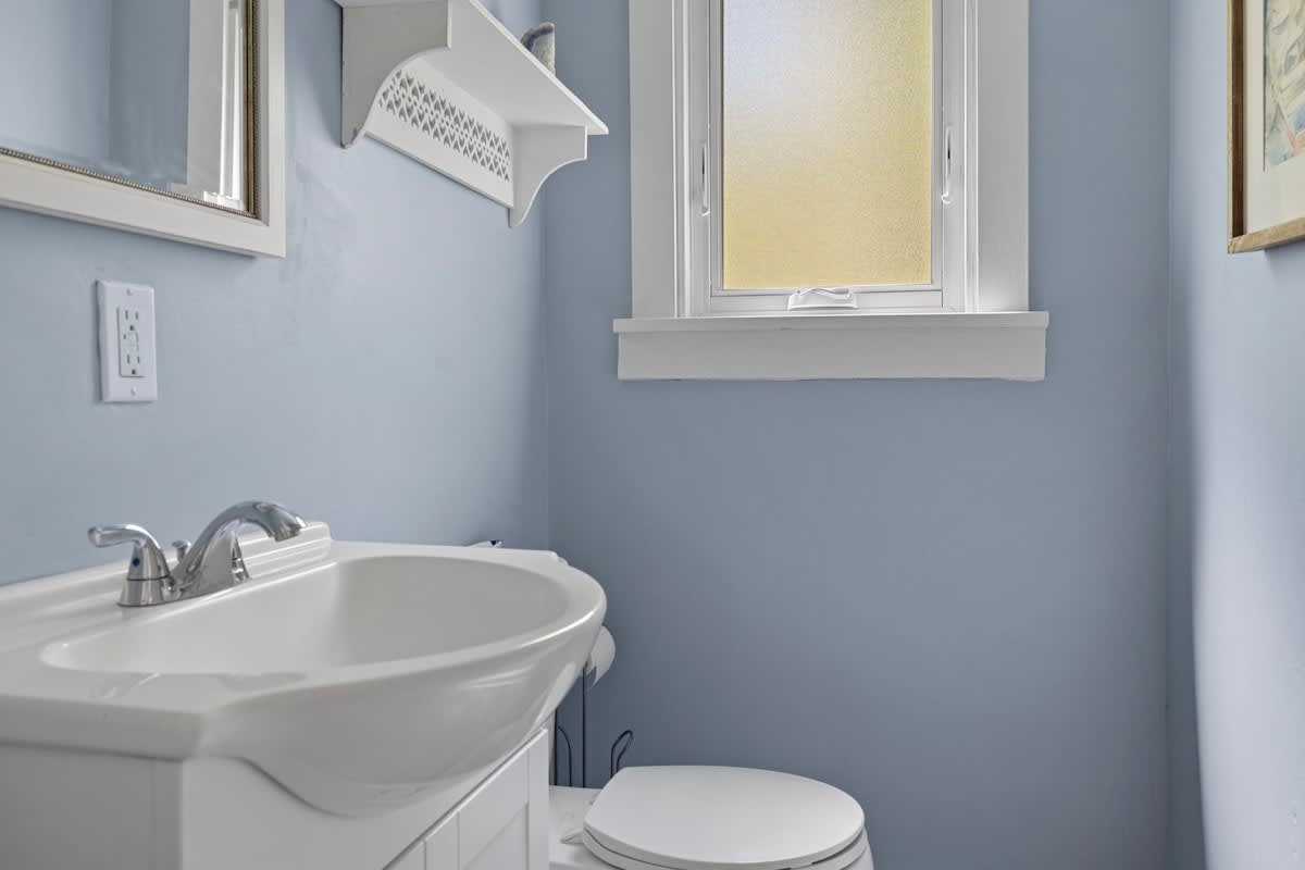 A splash of calm in the house—this cozy bathroom keeps it simple and sweet.
