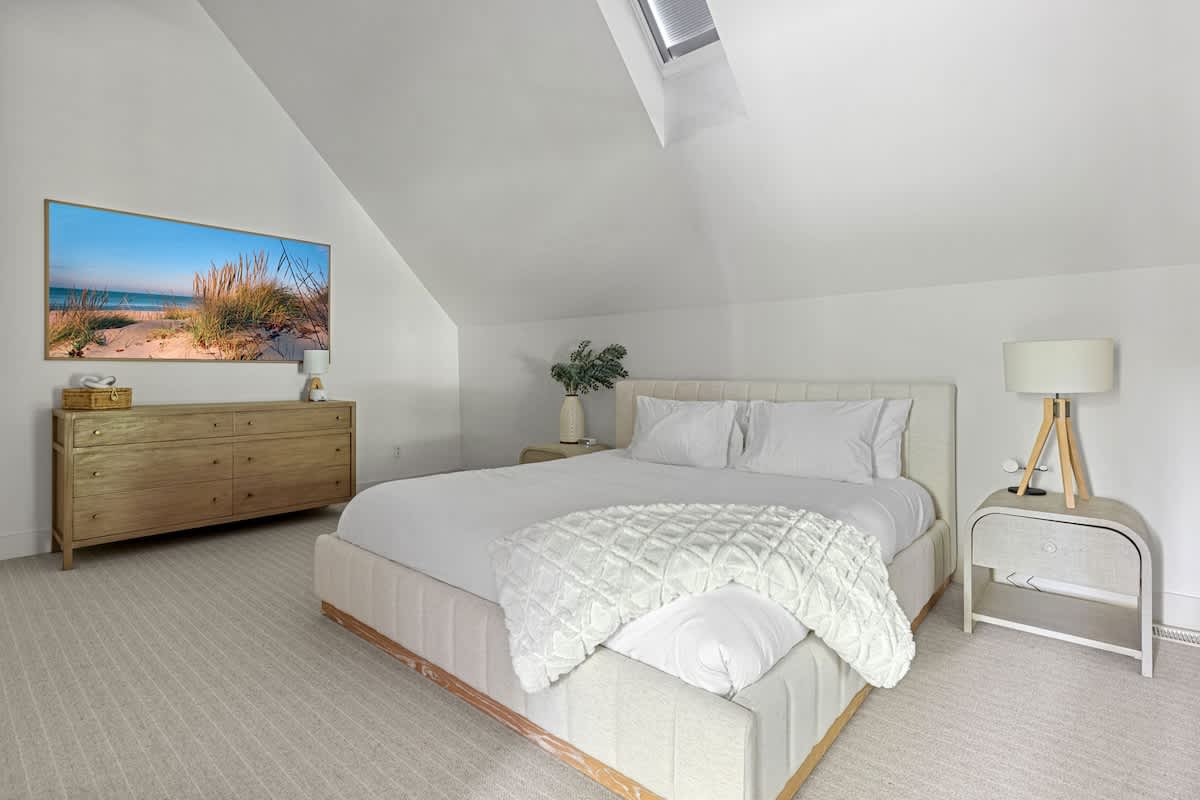 Primary bedroom is on the upper level & has a king-size bed.