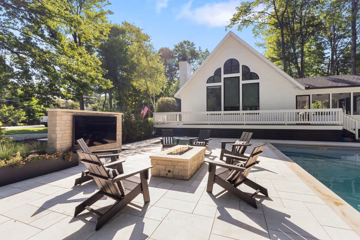 Light up the night with poolside fire pit fun.