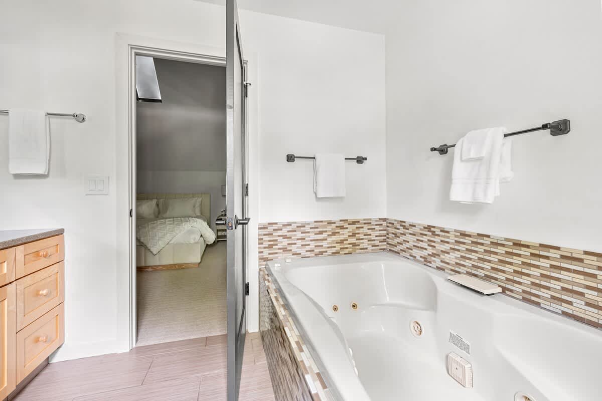 A tub that’s ready to melt away your stress—right next to your cozy retreat.