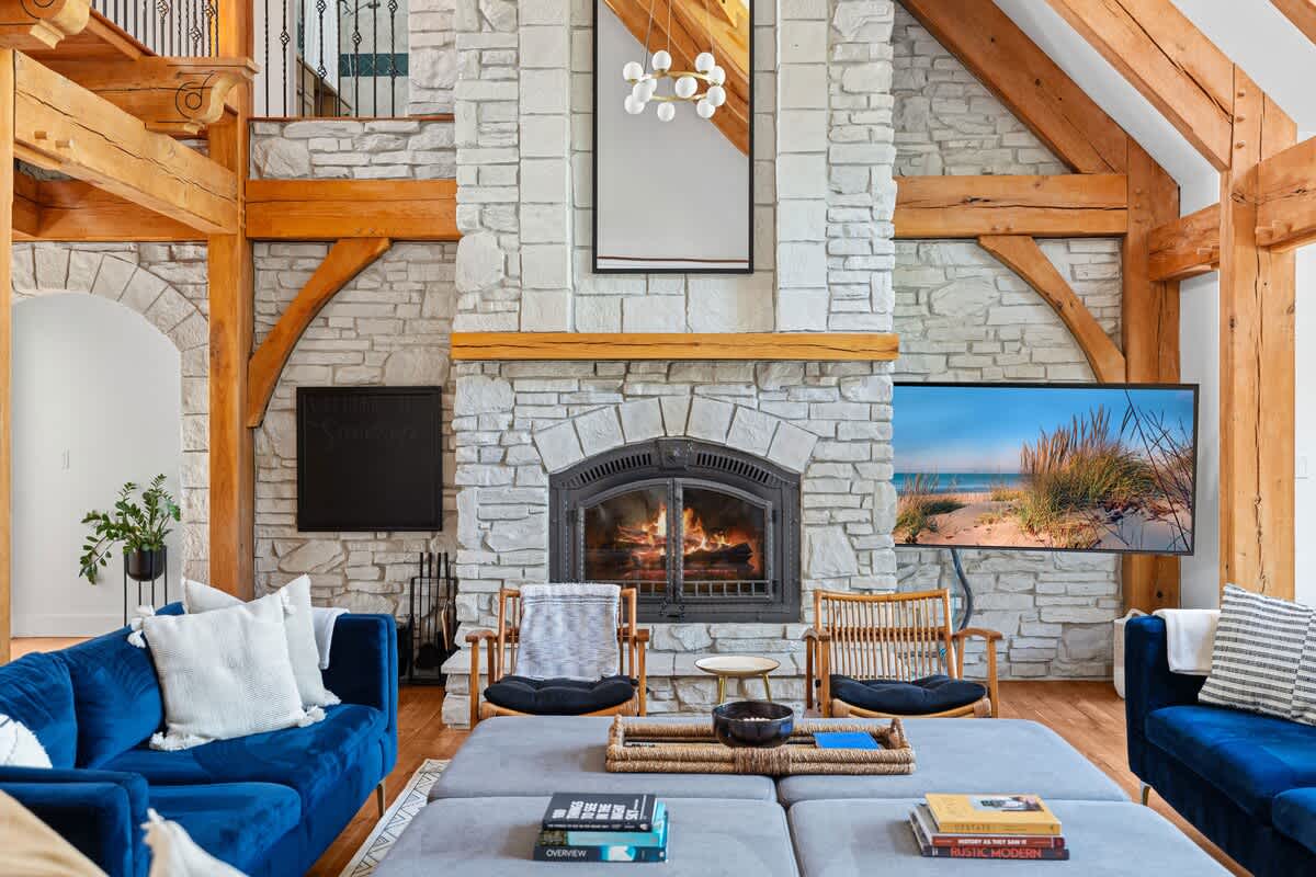 Stone, wood, and a crackling fire—this living room is peak relaxation.