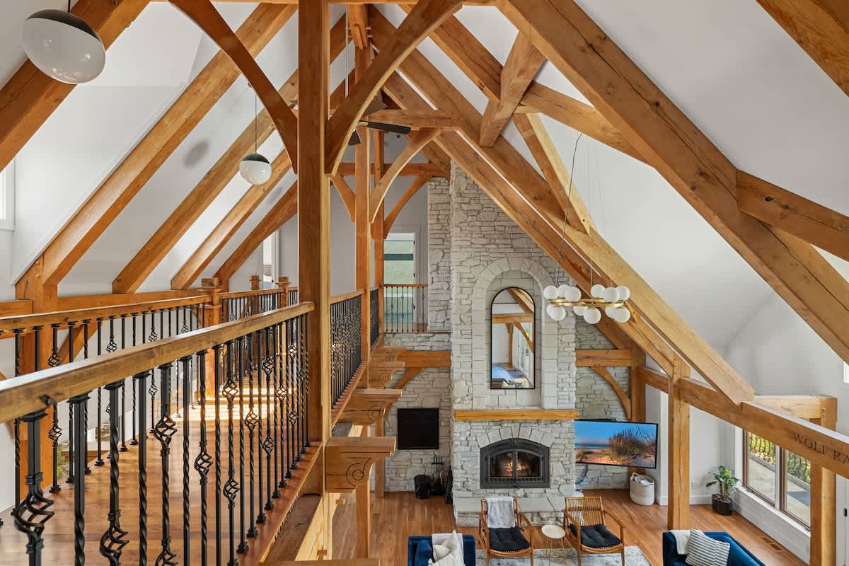 Cozy up under the beams and by the fire—this living room is everything.