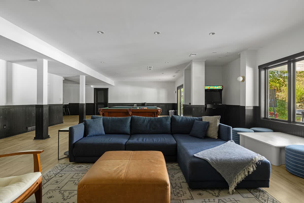 The ultimate chill zone: cozy seating, pool table, and arcade vibes.