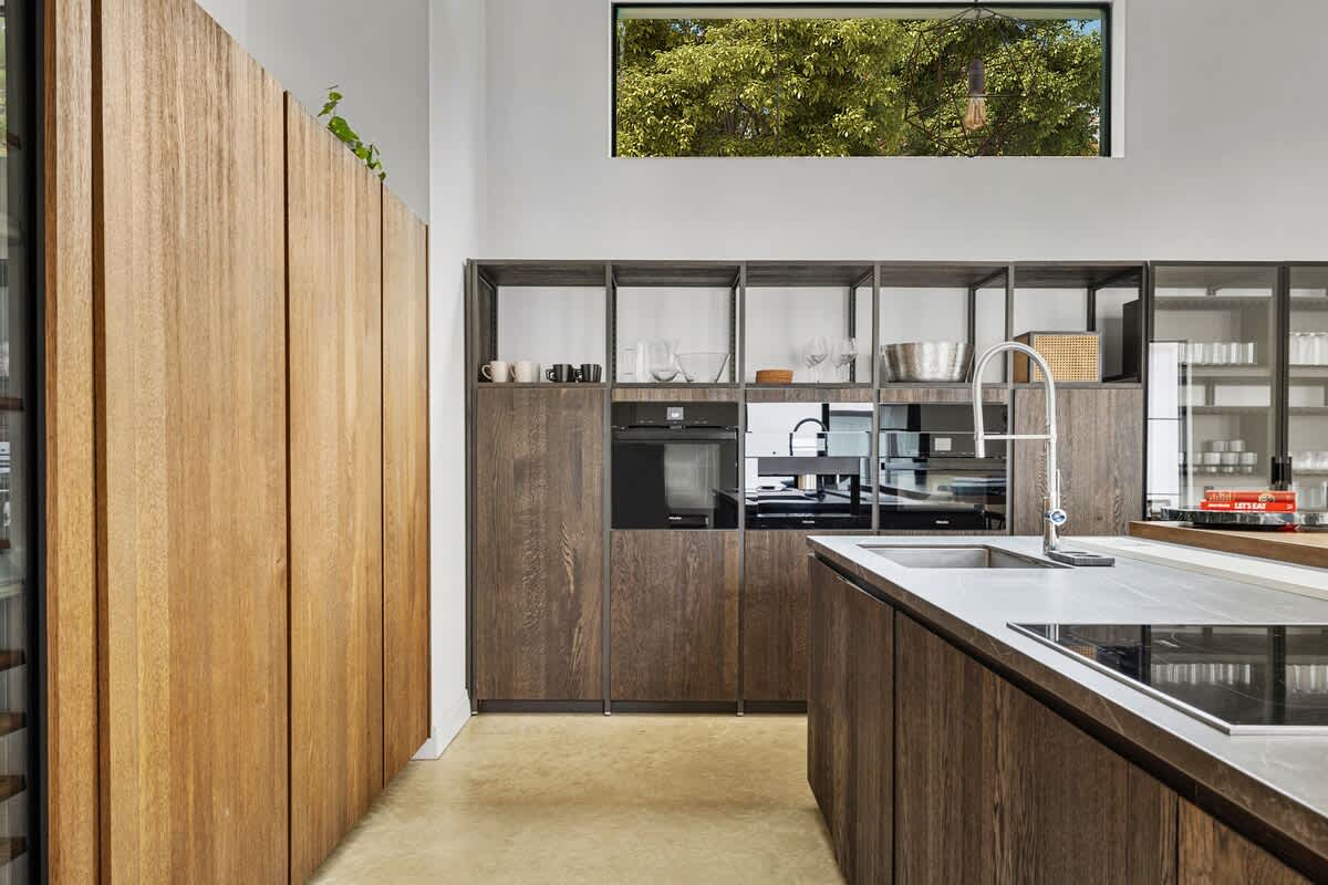 Your gourmet kitchen features sleek wood cabinetry and modern appliances, perfect for preparing memorable meals during your stay.