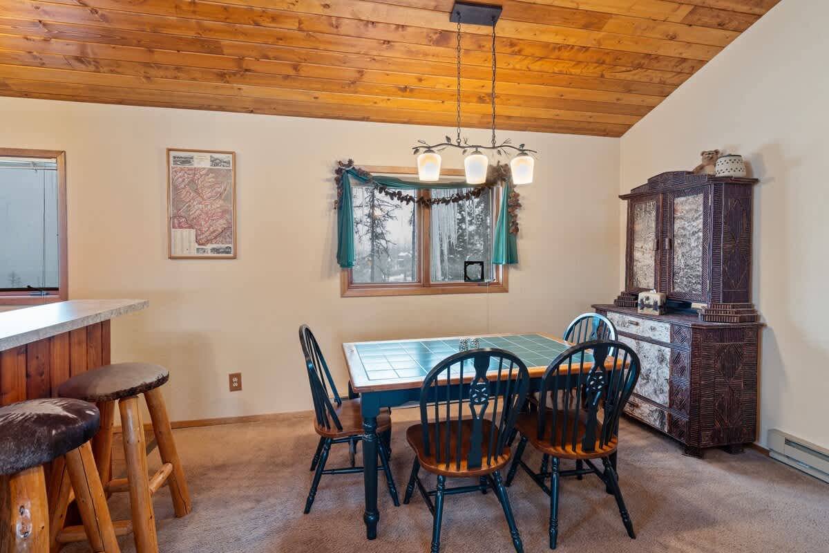 A warm and inviting dining room with a unique tile-topped table.