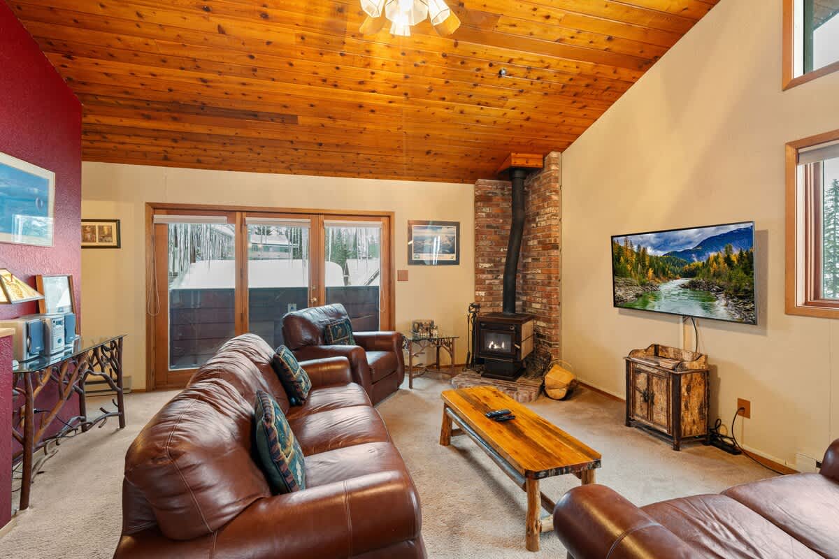 A warm and inviting living room with a wood-burning fireplace and a comfortable couch.