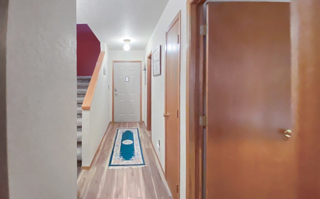A clean and minimalist entryway with a pop of color.