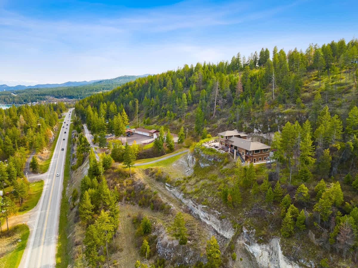Life’s better when your backyard is a forest and your driveway hugs a cliff.