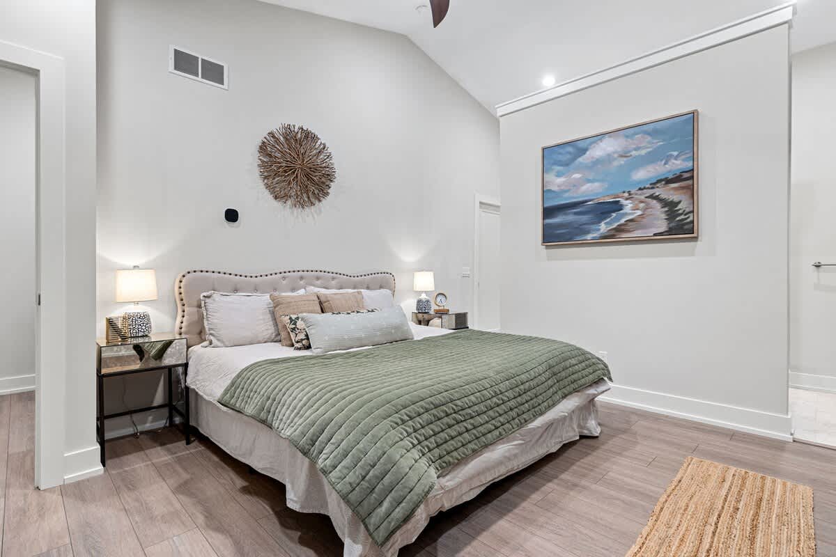 Primary bedroom is on the top level & has a king-size bed.