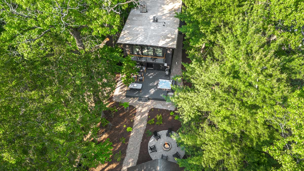 Tucked beneath the trees where modern comfort meets nature.