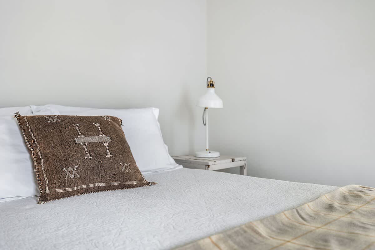 This room whispers, ‘Relax,’ and that pillow adds, ‘But make it stylish.’