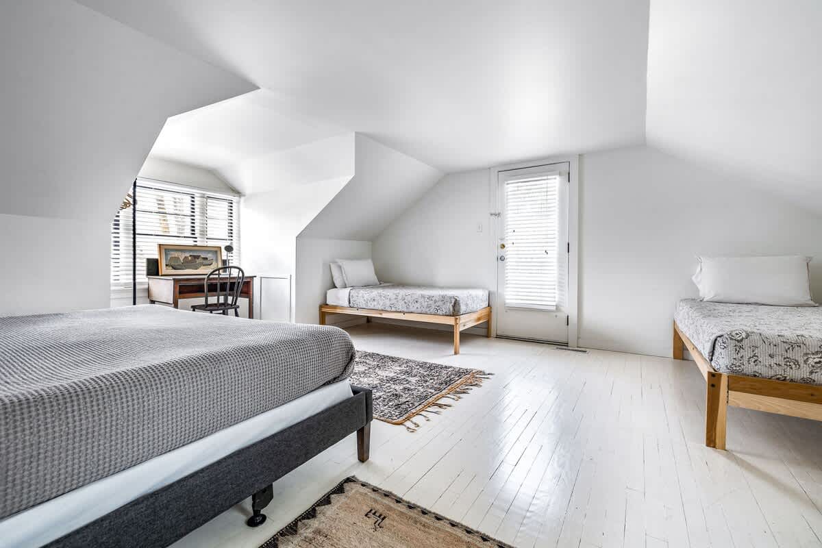 A triple threat of beds, light, and attic charm. Weekend retreat, anyone?