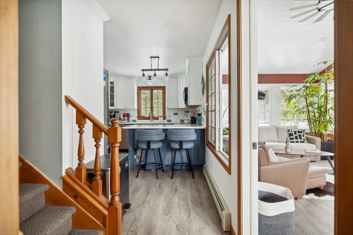 Peek inside: a kitchen built for conversation, a sunroom built for relaxation, and a staircase built for dramatic exits.