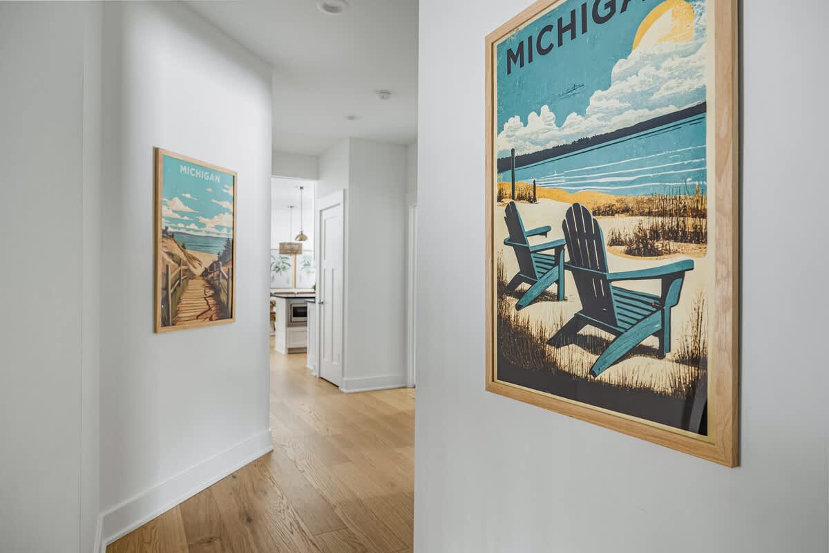 Welcoming hallway with charming Michigan-themed art—your cozy getaway starts here!