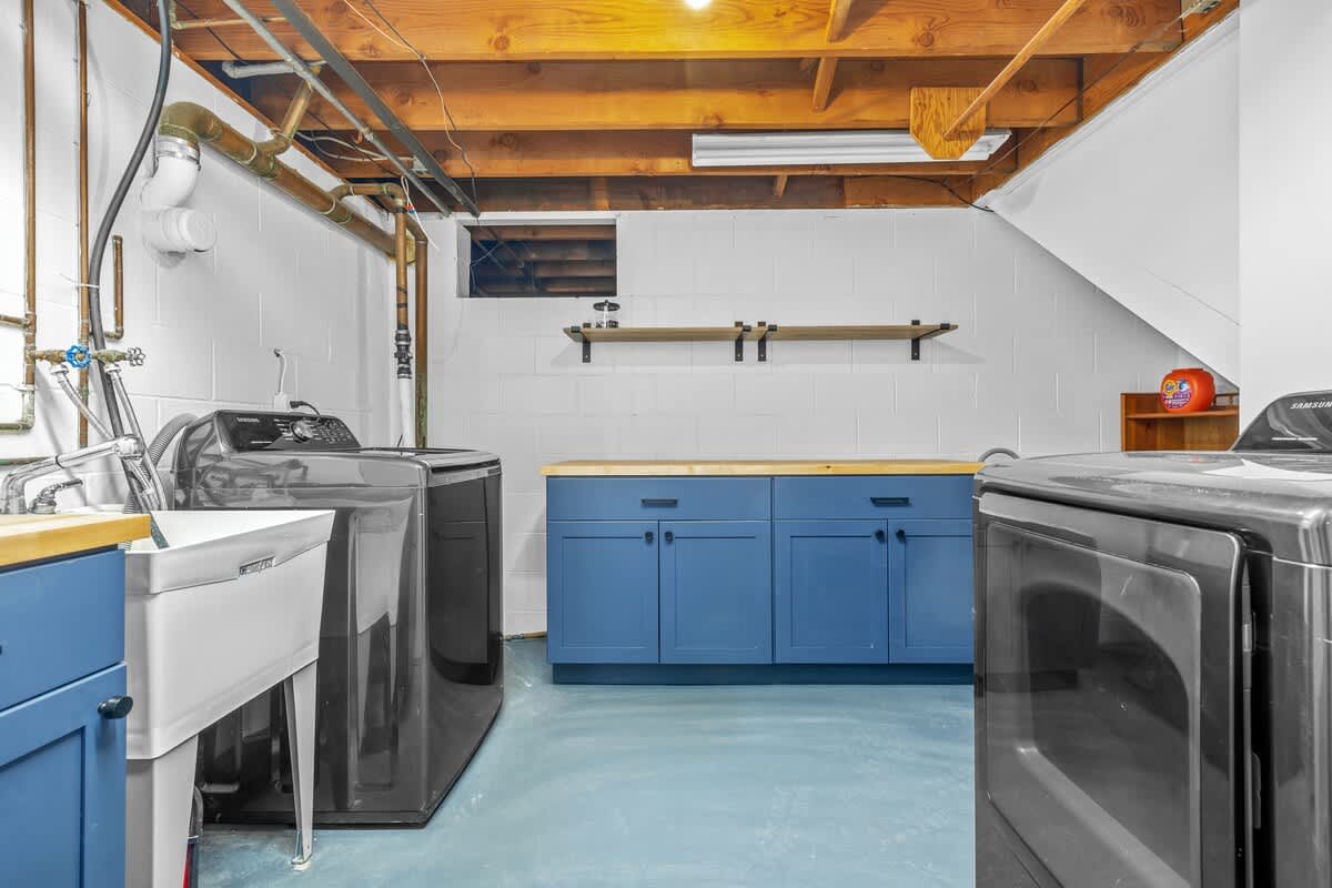 Bright, spacious laundry area with modern machines and bold style—chores made easy.