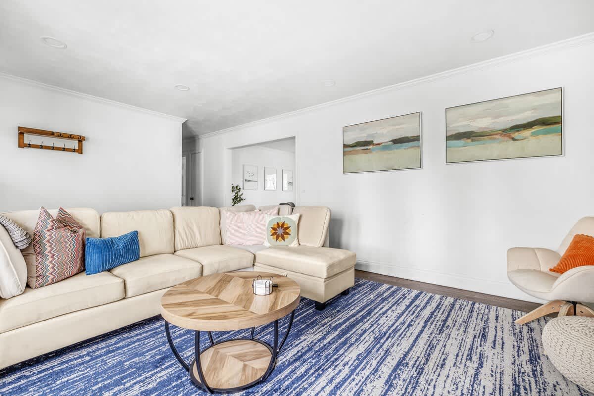 Our living room, adorned with beautiful blue and white rugs, is the perfect spot to unwind.