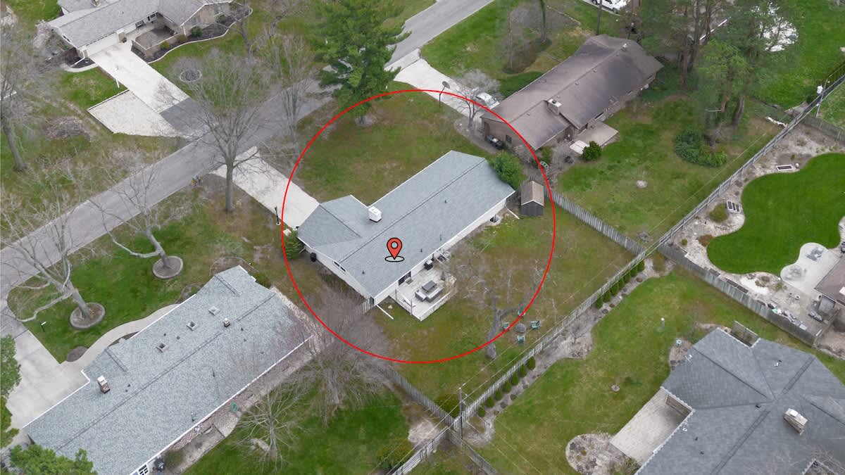 Aerial view of the property with a private yard, cozy patio, and room to relax—right where the pin drops!