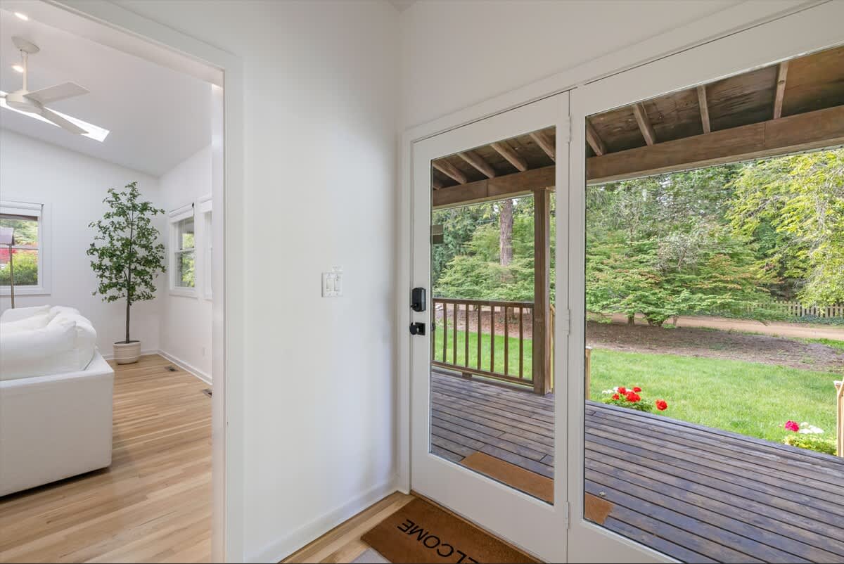 This sunlit entryway opens to a charming porch.