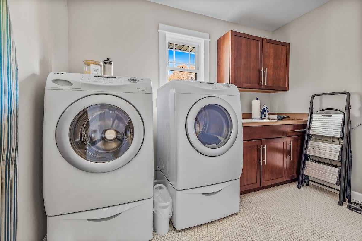 Washer, dryer, and cabinet space—practical never looked so polished.