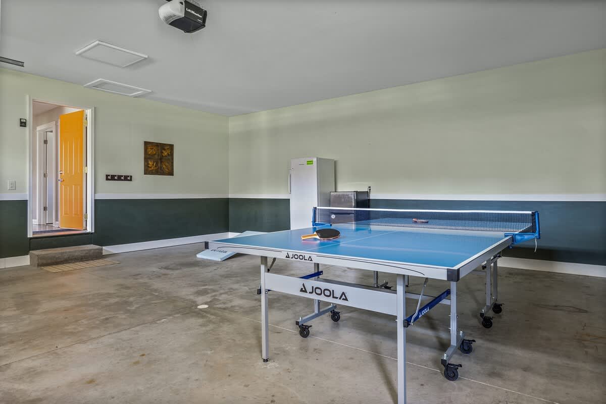 Bright and upscale game space featuring a Joola ping pong table.
