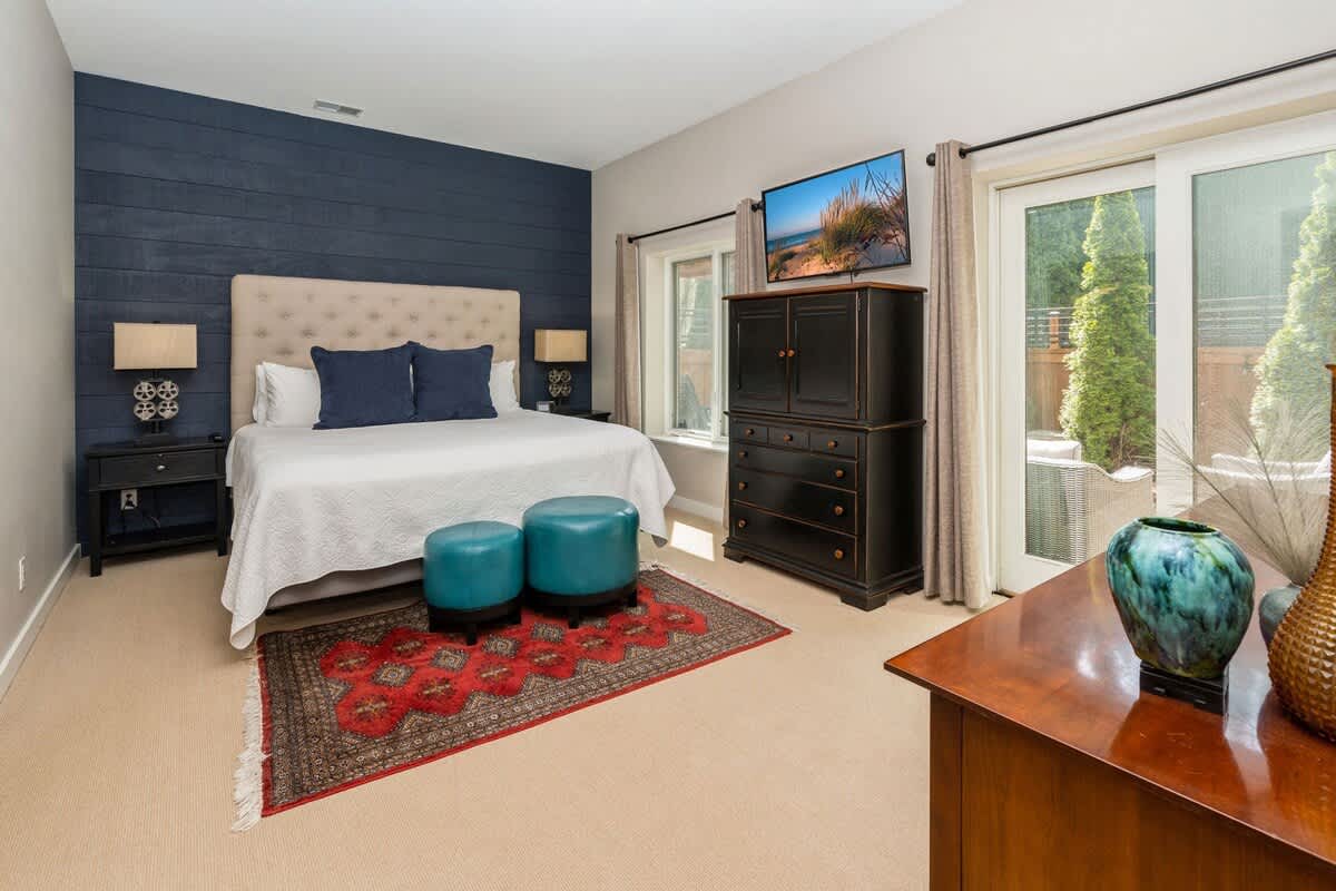 Primary bedroom has a king-size bed with outdoor access.