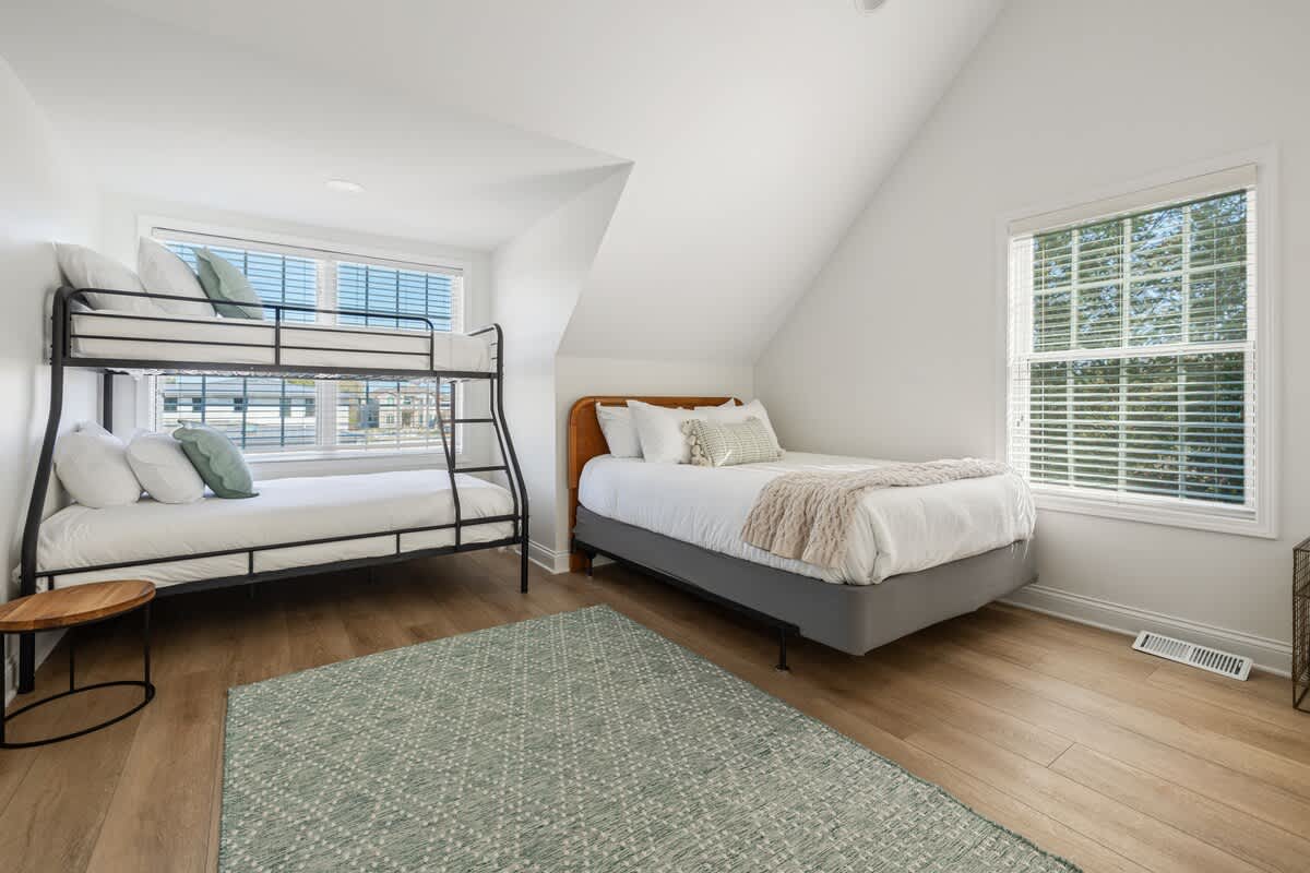 Bedroom 4 is on the upper level & has a queen-size bed, single-over-full bunkbed and twin bunkbed.