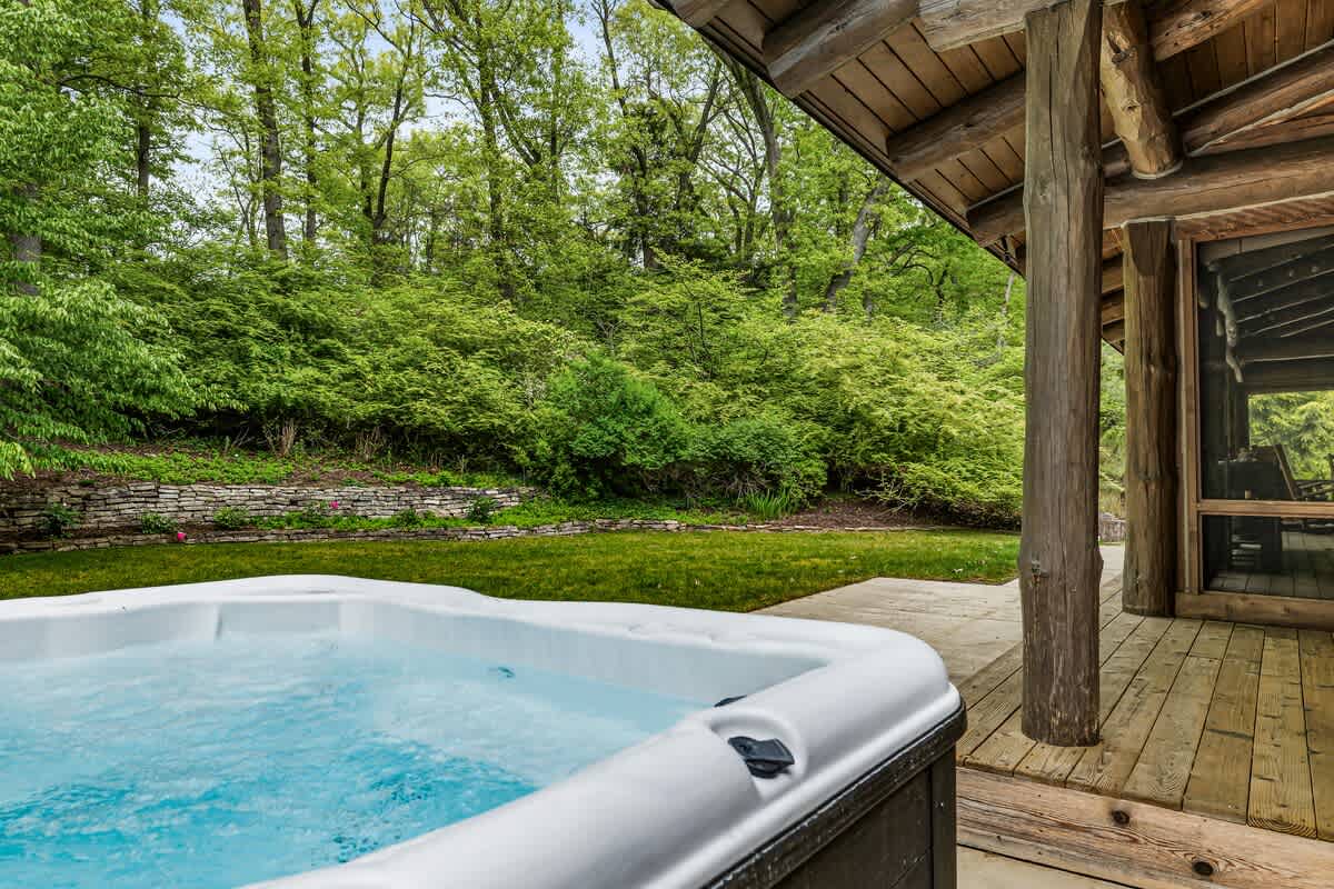 Dip into warm soak in the hot tub, surrounded by the beauty of the woods.