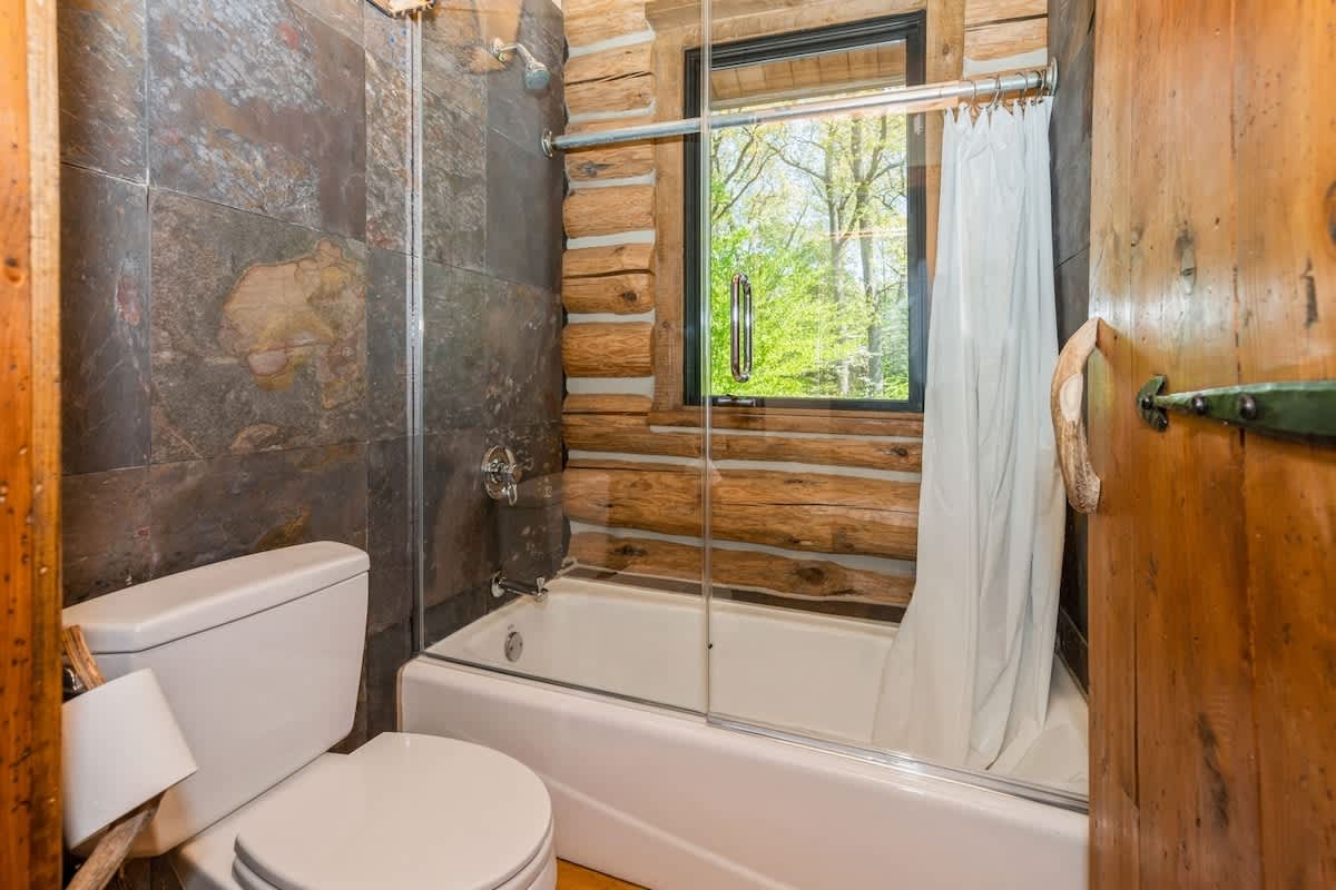 Wood walls, stone tile, and a soak that hits just right.
