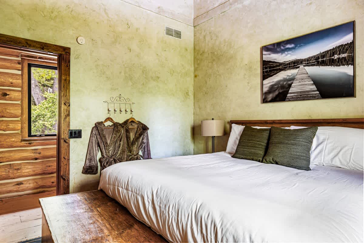 Serene bedroom with a striking painting invites you to unwind in style.