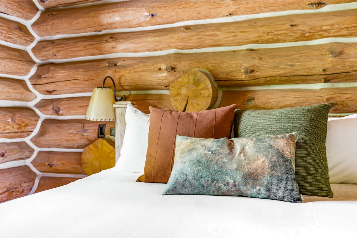 Plush pillows and a wooden backdrop make this bed perfect for unwinding.