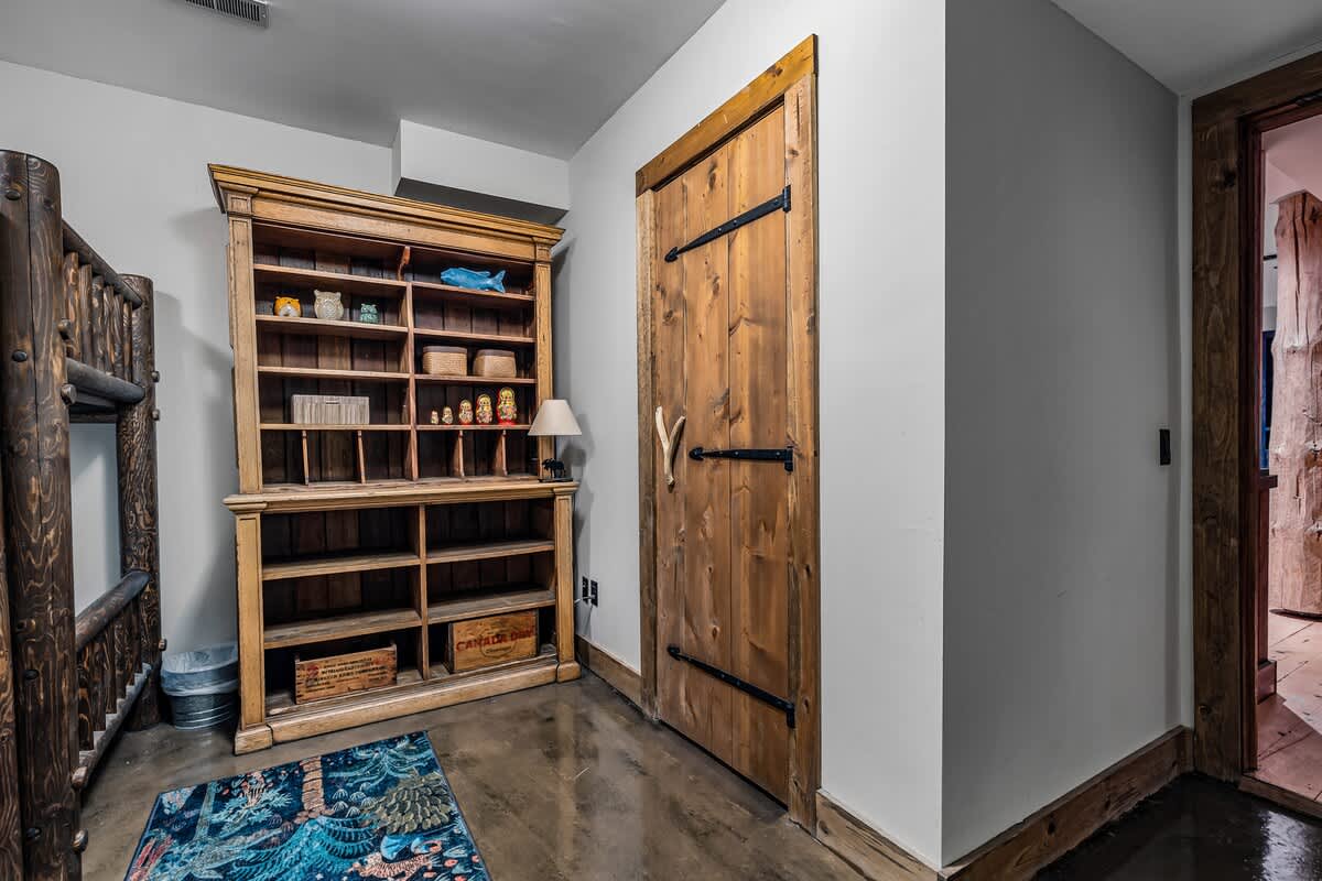 This serene space with a wooden door and bookcase invites you to unwind.