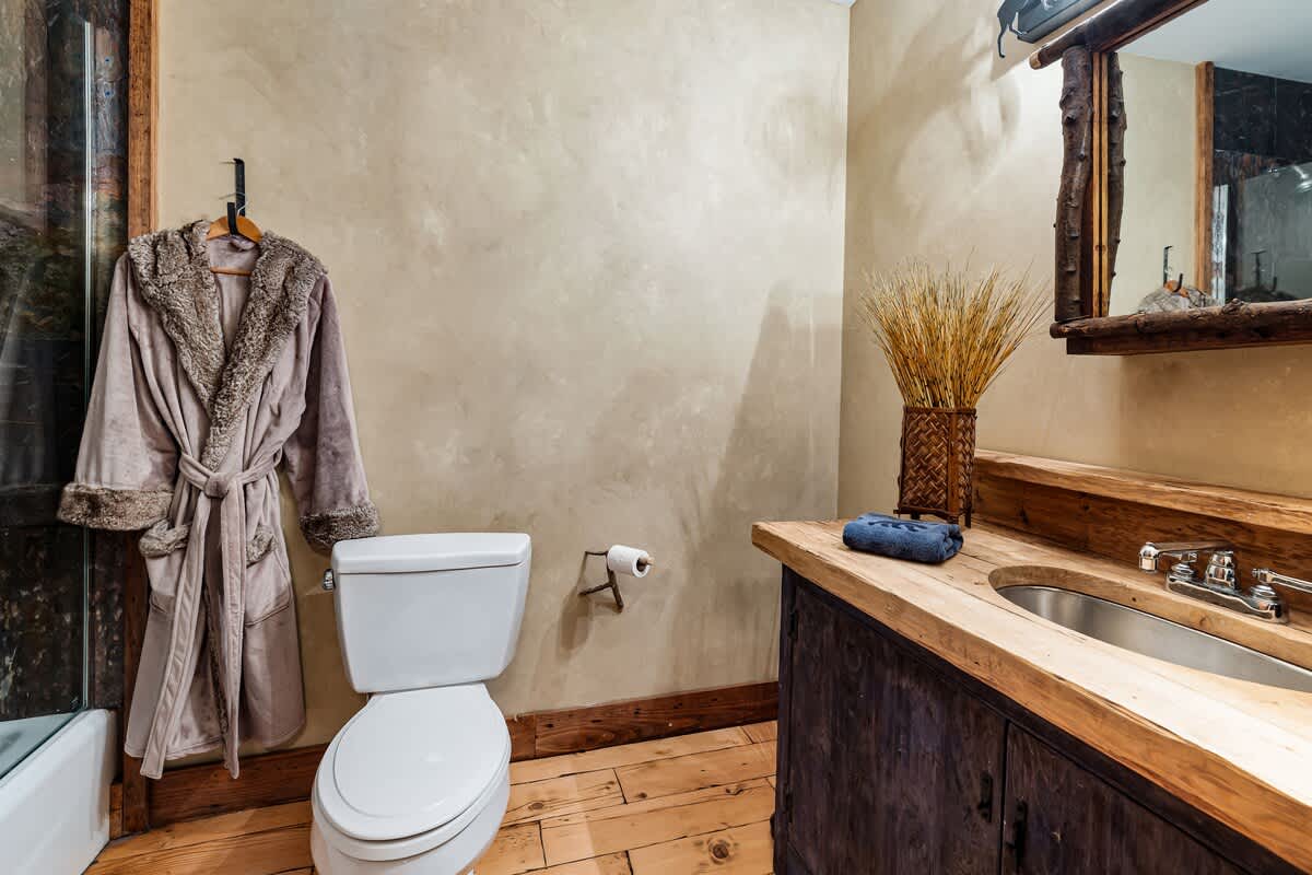 The wooden counter boosts style and brings calm to the bathroom.