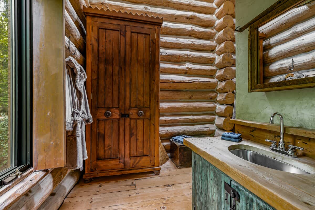 Wood textures and modern touches create a serene sensory sanctuary in the bathroom.