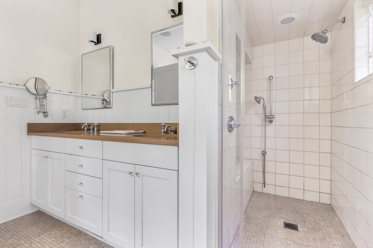Start the day refreshed in this sunlit walk-in shower retreat.