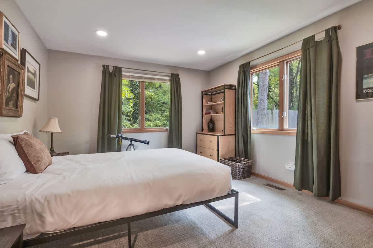 Serenity meets simplicity in this forest-view room.