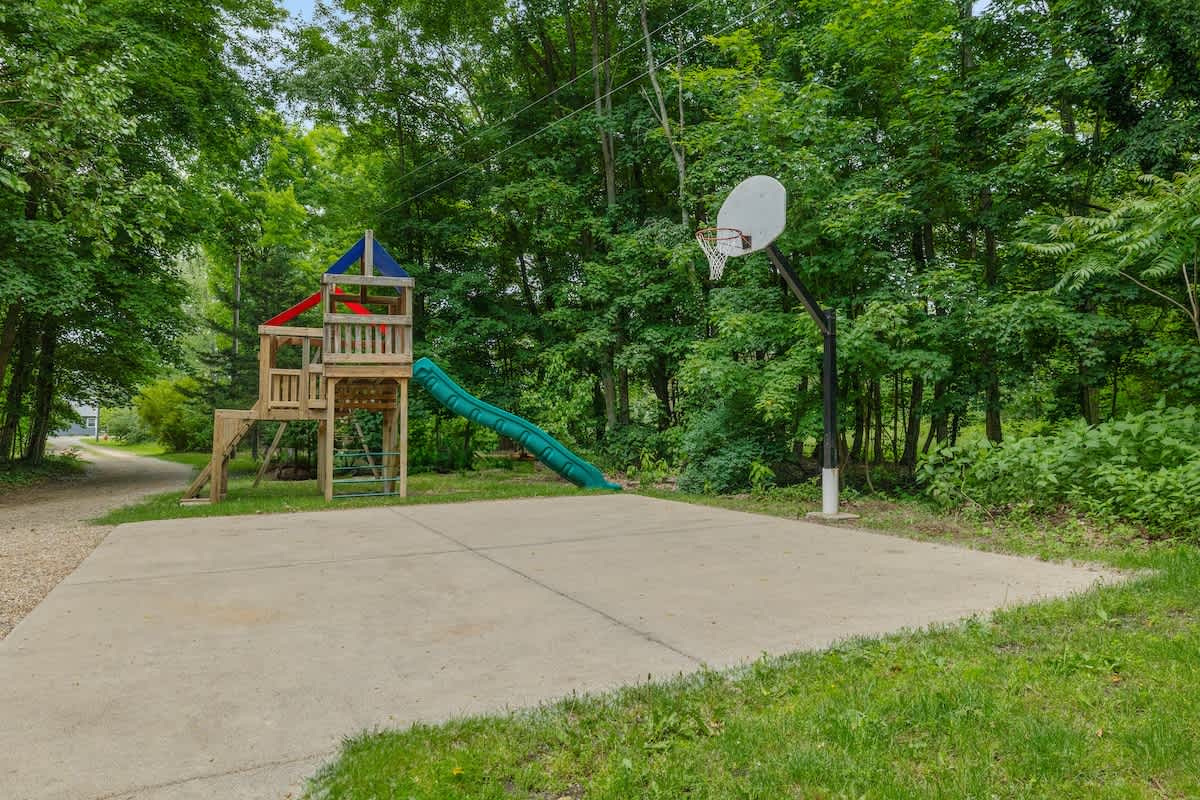 Shoot hoops or slide into fun—backyard play at its finest.