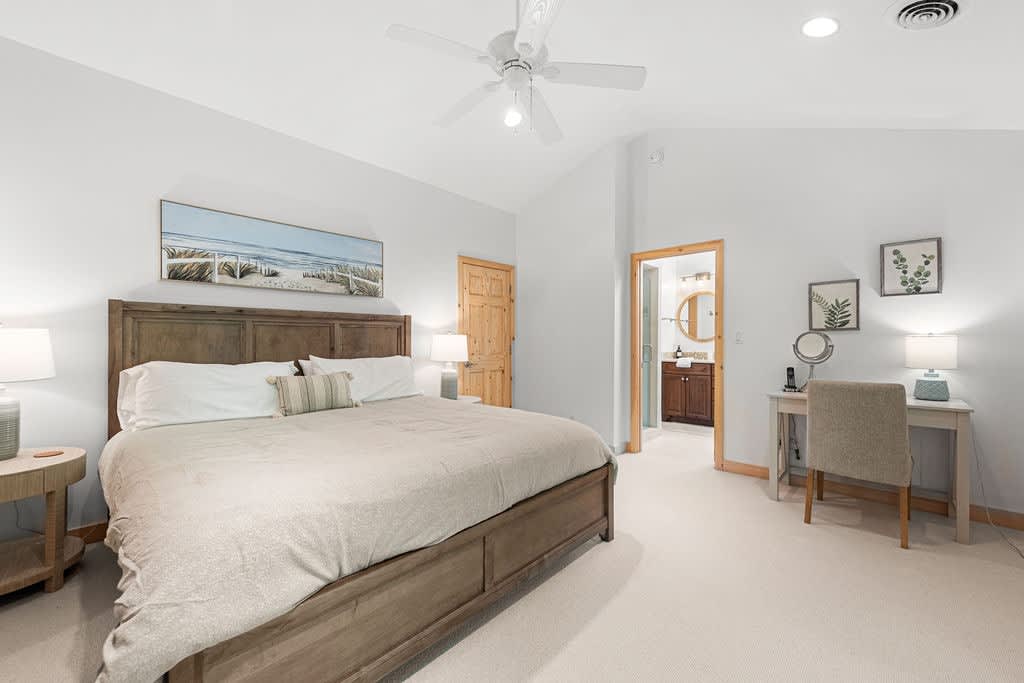 Primary bedroom is on the upper level & has a king-size bed.