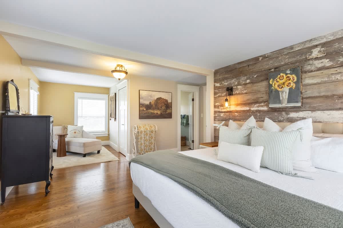 The primary bedroom is on the upper level & has a king-size bed and a daybed.