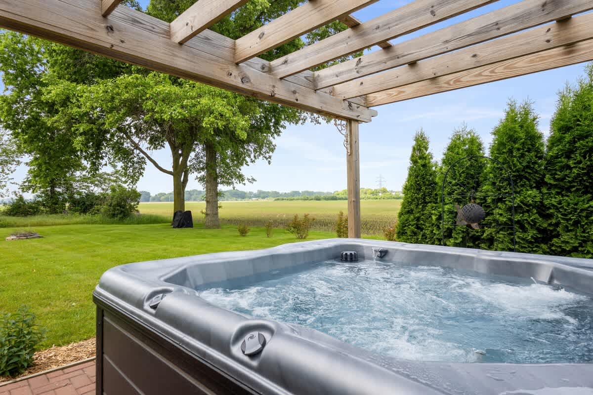 Soak under the pergola with peaceful views of open fields.