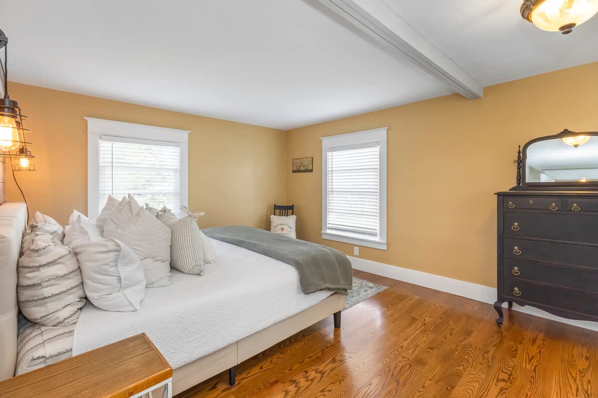 A serene bedroom retreat with rich wood and golden glow.
