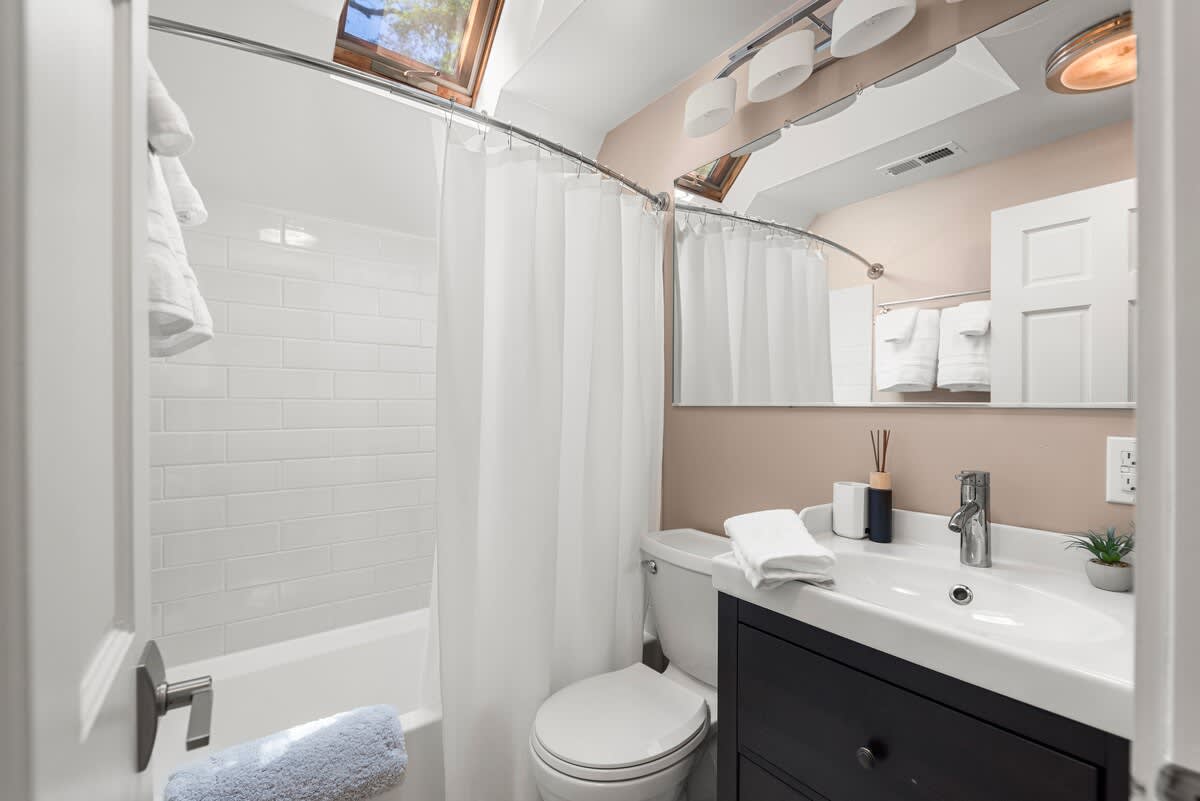 A sunlit soak awaits beneath the skylight.
