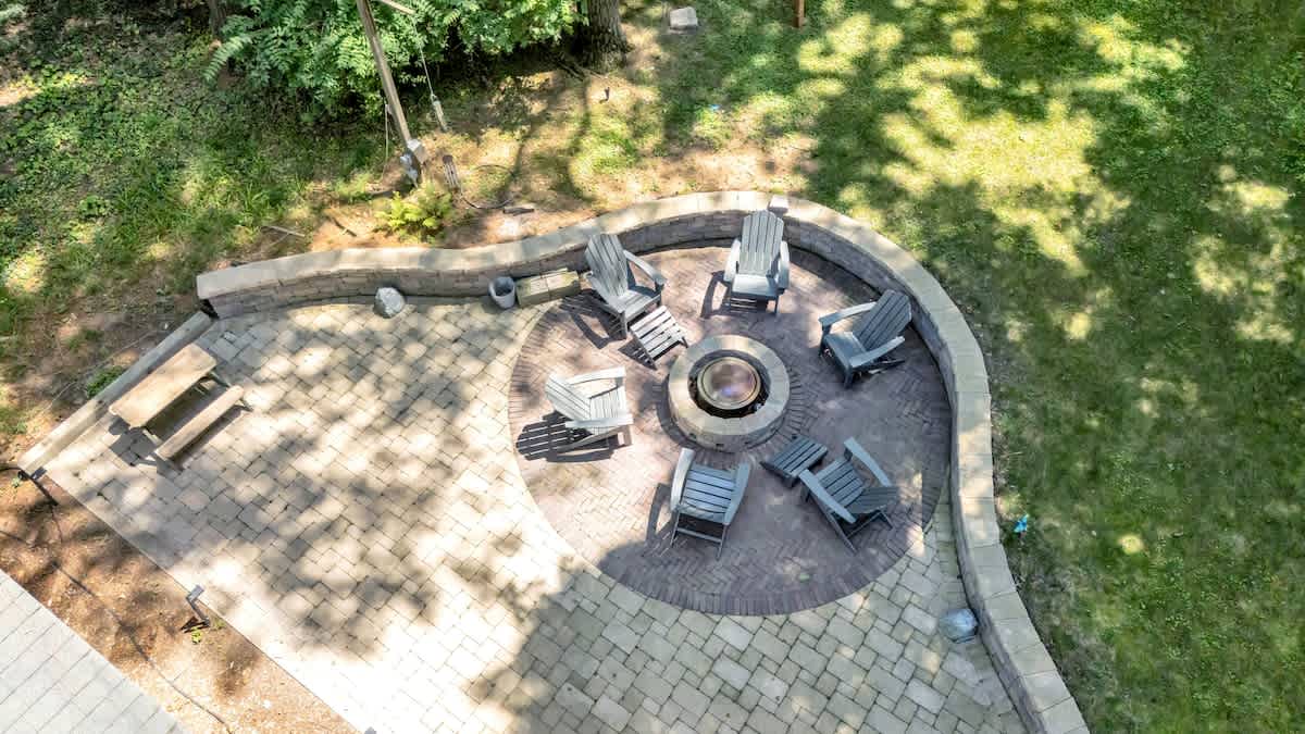 Fire pit vibes: round seating, glowing flames, good times.