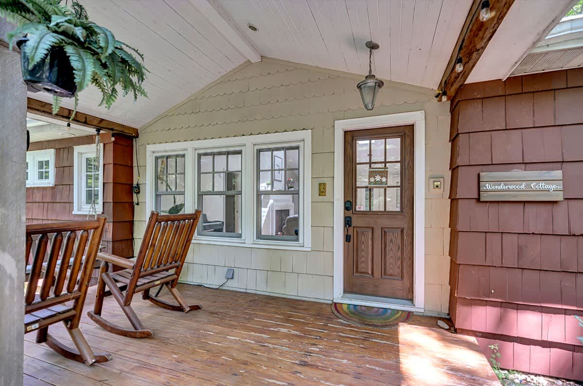 Welcome to Wonderwood Cottage, where the front porch sets the tone for a warm and inviting stay.