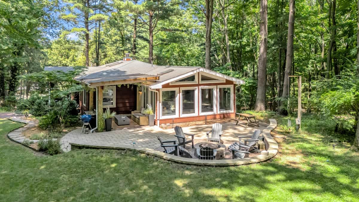 A private woodland escape with fire pit and outdoor lounge.