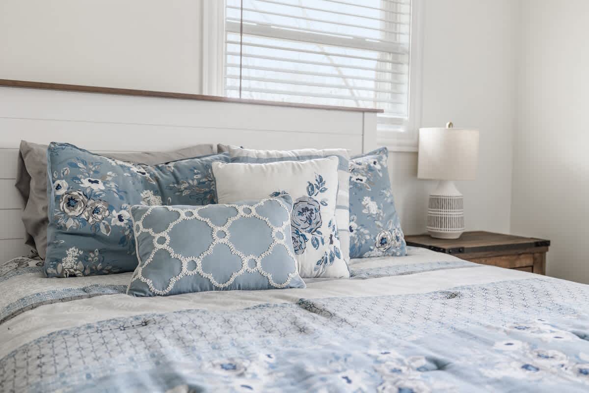 Soft pillows, cozy textures, and a soothing blue palette designed for comfort.