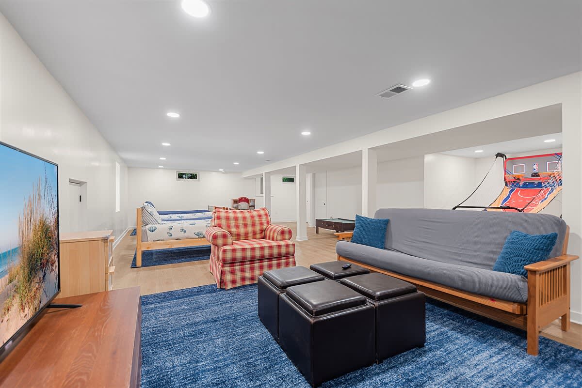 Family hangout space with games, TV & comfy seating.