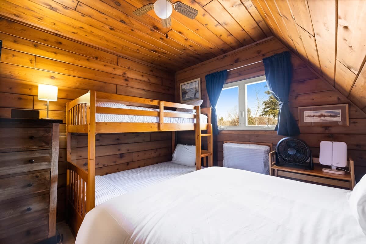 Relax and unwind in this bright bedroom after a day outdoors.