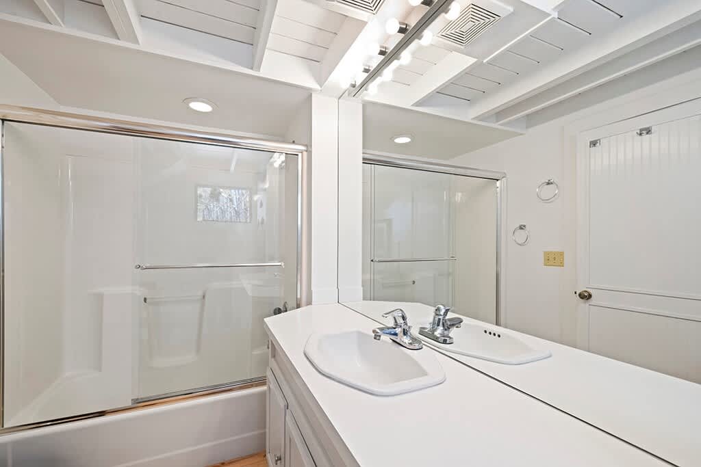 A bright, uncluttered bath that keeps The Cottage feeling fresh and easy.